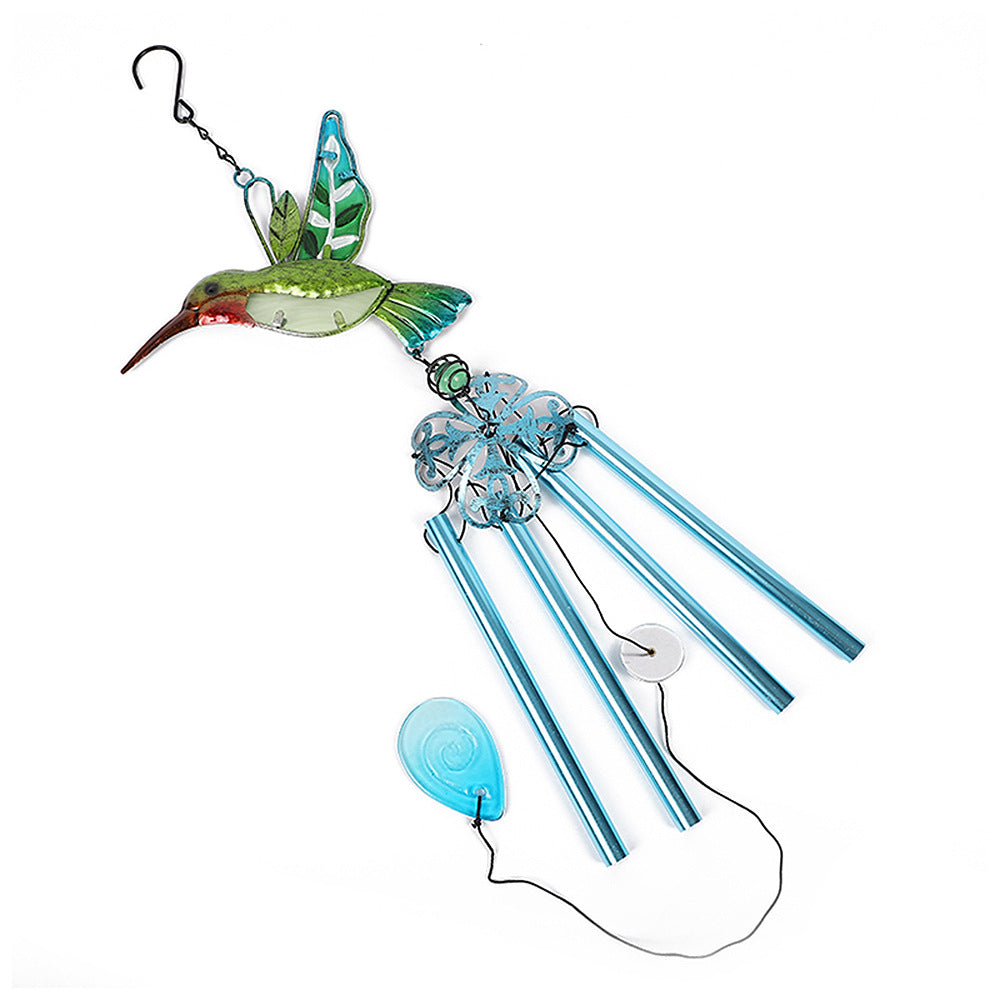 Decorative wind chime hanging in garden setting